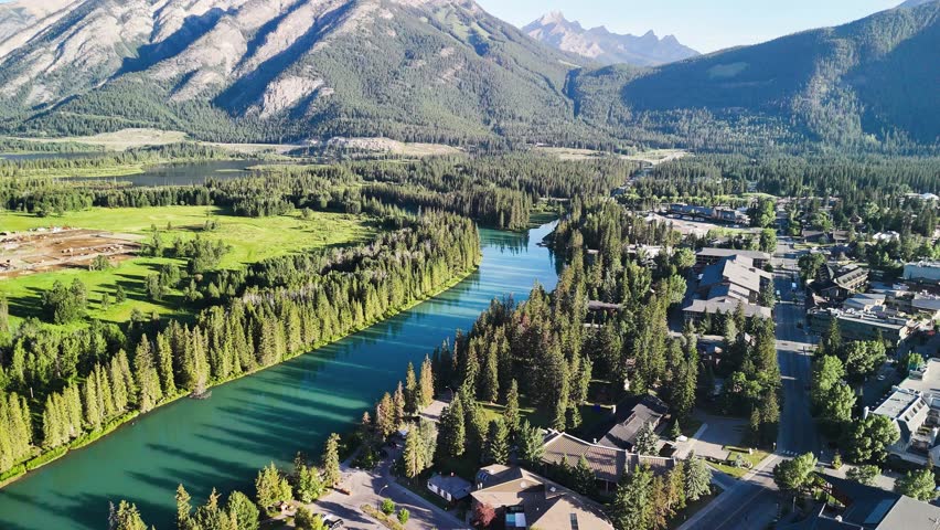 Panoramic aerial shot of Banff National Park with lush green valley in summer