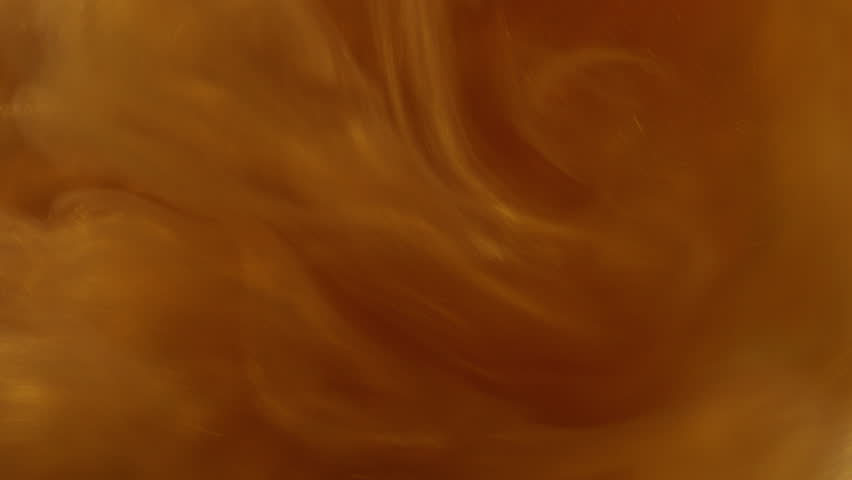 Paint glitter. Golden swirl. Shimmering pink sparkly defocused vortex. Glossy orange liquid ink warm color texture with metal shiny powder.