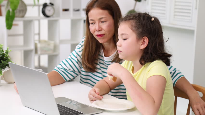 parenting; togetherness; bonding; mom; gesture; look; daughter; emotion; focus; joy; mother; relax; smile; two; indoors; kid; children; refreshment; person; milk; juice; nutrition; life; love; drinkin