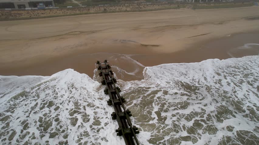 foggy moody ocean jetty drone video foggy day big waves and whitecaps