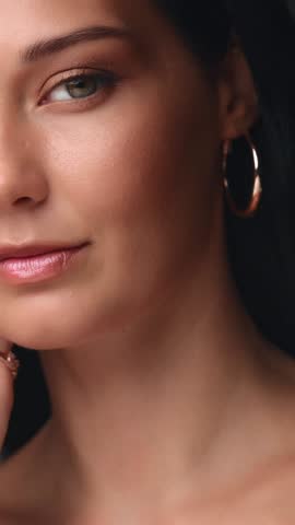 Close-up shot of a beautiful Caucasian woman with natural makeup gently touching her face, showcasing elegance, skincare, and cosmetic beauty in a high-quality promo video.