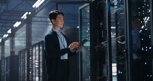 Data Center Administrator Using Tablet Computer. Asian Maintenance Specialist Working on Cyber Security and Network Protection in AI Computing Facility. Engineer Checking Server Farm Analytics - Powered by Shutterstock - Get 15% off with code: PIKWIZARD15