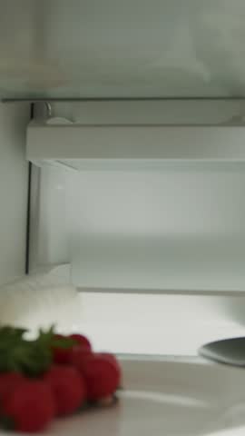 Portrait young woman opens fridge door looks inside take food and close. Refrigerator, lunch, preparing. Close up. Slow motion