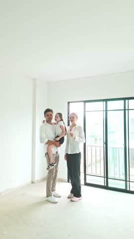 Happy young family exploring their new home in a bright empty room. Concept of house hunting, moving in, and real estate investment. Ideal for property marketing and home ownership visuals.