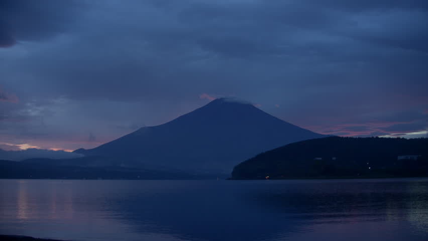 Iconic Japanese Dusk – Blue twilight captures Mt. Fuji’s shape on calm waters.
