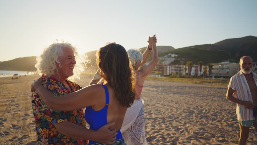 Happy senior people at the beach. retired friends dancing joyfully during vibrant sunset beach gathering, celebrating golden years with active senior energy and carefree friendship - Powered by Shutterstock - Get 15% off with code: PIKWIZARD15
