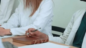 Healthcare team reviewing medical data on digital devices, collaborating closely in hospital setting, sharing insights and professional expertise, close up hands of doctors during brainstorm meeting  - Powered by Shutterstock - Get 15% off with code: PIKWIZARD15