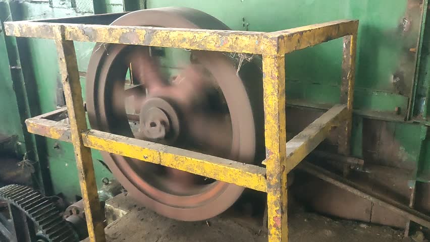 A spinning flywheel rotates rapidly, storing powerful kinetic energy as it whirls with unstoppable speed and mechanical precision.