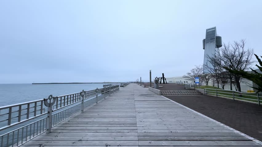 Wooden boardwalk along Aomori Bay with sea views and a modern observation tower