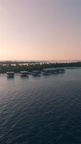 Sunset silhoutte of luxury over water villas on a tropical island in the Maldives