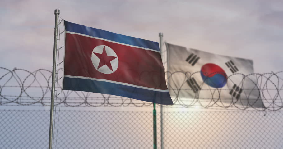 South Korea and North Korea waving flags on country border concept. Both Koreas blowing banner with barbed wire fence.