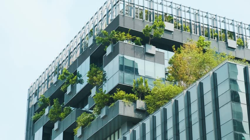 Modern eco-friendly architecture with vertical garden and greenery on office glass building in urban environment in Bangkok city, Thailand. Green city and sustainable design for reduce carbon dioxide