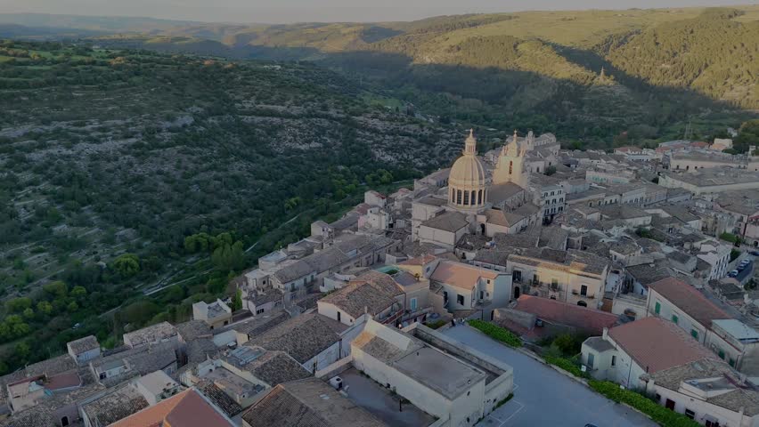Flight around Ragusa Ibla city center during sunset with the beautiful hills landscape in the background
