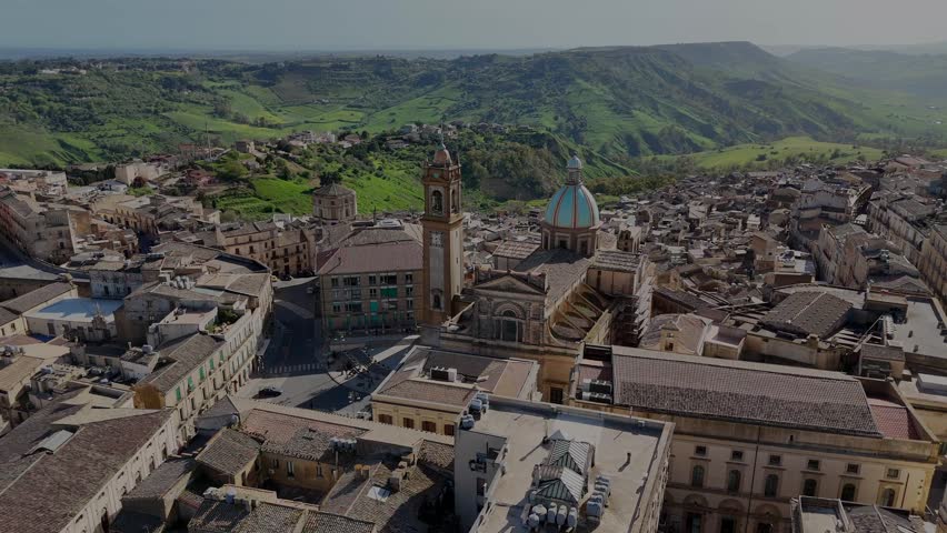 Flight around Caltagirone’s cathedral with the countryside hills in background during a spring day