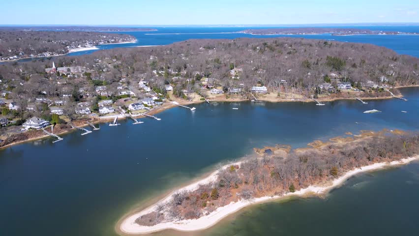Drone footage of Bird Island between Northport Bay and Centerport Harbor, showing coastal homes, marinas, and the shoreline of Long Island’s North Shore on a peaceful sunny day.