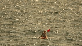 Kayaking Water Paddle Person - A single person is kayaking on a body of water, paddling with a red paddle. The person appears to be wearing a brown life jacket. - Powered by Shutterstock - Get 15% off with code: PIKWIZARD15