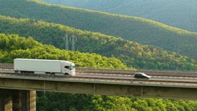 Cargo delivery truck driving along scenic mountain viaduct highway with green landscape - Powered by Shutterstock - Get 15% off with code: PIKWIZARD15