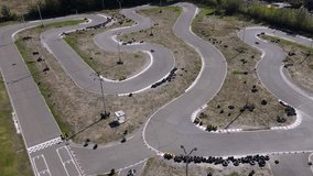 Go-kart on a race track. Aerial  view of go-kart racing on winding track. The outdoor venue features several turns and pits, perfect for drivers of all skill levels. - Powered by Shutterstock - Get 15% off with code: PIKWIZARD15