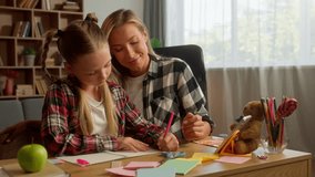 Carefree Caucasian family daughter learning mother helping educate at home girl student schoolgirl writing child drawing mom pointing woman speak lesson parent kid study together tutoring schoolwork - Powered by Shutterstock - Get 15% off with code: PIKWIZARD15