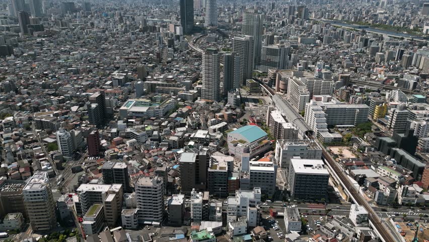 Aerial Scenic Urban Drone Footage of a neighborhood, streets and buildings in the Capital City of Tokyo, Japan on a Sunny Day