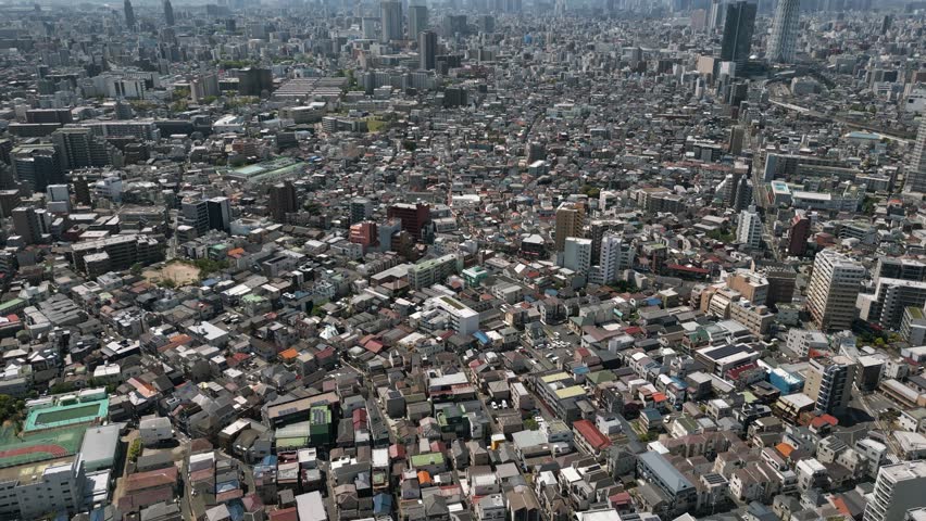 Aerial Scenic Urban Drone Footage of a neighborhood, streets and buildings in the Capital City of Tokyo, Japan on a Sunny Day