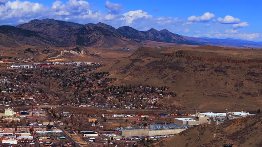 Beautiful crisp cold winter day sunny clouds downtown historic Golden Colorado aerial drone North Table Mountain Flat Irons Boulder highway 93 Golden Gate Canyon Coors Beer Factory down jib motion