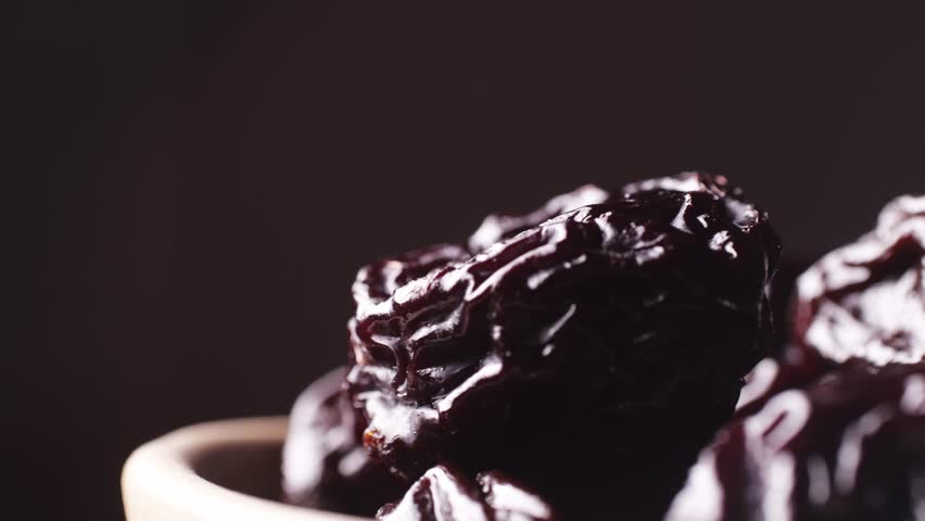 Dried plums on the kitchen table, dried sweet pitted prunes vegan healthy fruits.