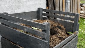 Empty the Full Grass Catcher Into the Compost Pile. 4k Video - Powered by Shutterstock - Get 15% off with code: PIKWIZARD15