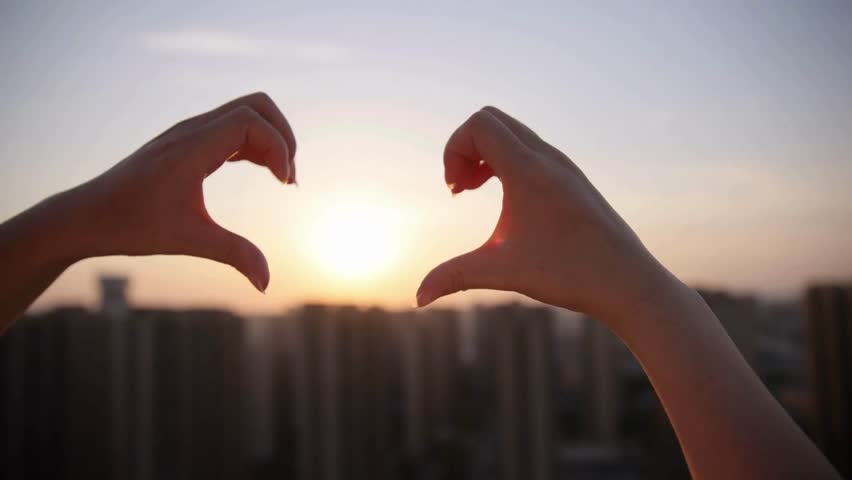 Silhouette of Hands Forming Heart Shape at Sunset