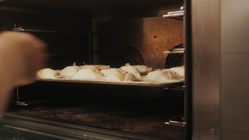Man cooking empanadas argetinian pie, Samosa tart, traditional bakery from argentina, chef filling dough in home with meat and vegetables, homemade spanish empanadas
