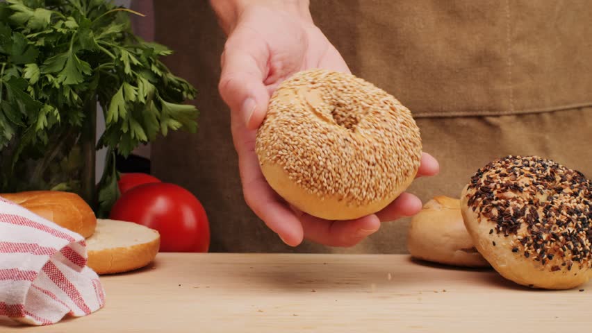 Bagel sandwich brunch, lunch plate of a bagel with smoked salmon and cream cheese and ham, close up morning cafe menu.