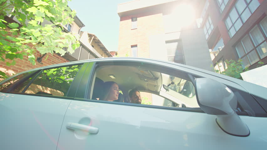 Happy smiling joyful Caucasian couple family buying apartment flat man male guy driver showing new home keys rental house rent real estate housing surprised woman female girl excited inside car auto