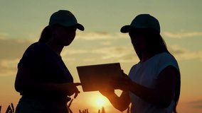 Teamwork of women business conclusion of deal handshake slow motion. Two farmers with tablet shaking hands on wheat field, sun Agriculture. Handshake of women partners on wheat field field, silhouette - Powered by Shutterstock - Get 15% off with code: PIKWIZARD15