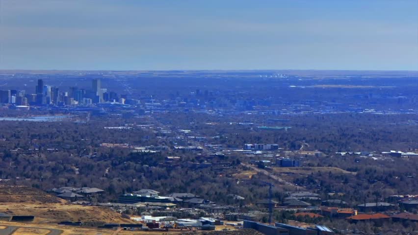 Downtown Denver cityscape from Lookout Mountain Golden North Table Mesa aerial drone Colorado daytime winter sunny clouds neighborhood Front Range Rocky Mountains Arvada Lakewood pan left motion