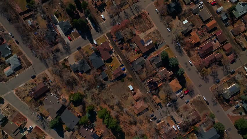 Birdseye aerial drone view perspective downtown Golden Colorado neighborhood buildings streets homes winter sunny daytime Denver front range Morrison Boulder upwards motion