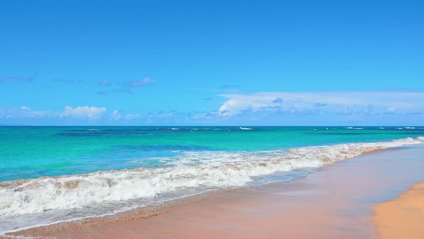 Summer Caribbean sea wave background on tropical beach. Exotic water landscape with clouds on horizon. Sunny sky and calm blue ocean. Tropical island travel. Calm ocean nature.