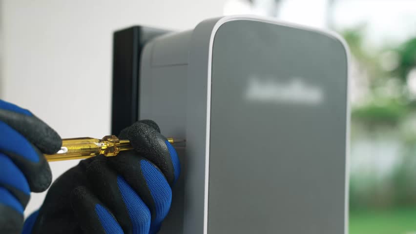 Qualified technician install home EV charging station, providing maintenance service for electric vehicle's battery charging platform at home. EV car technology for residential utilization. Fastidious