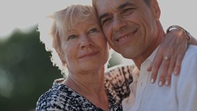 Happy senior couple sharing intimate moments outdoors - Powered by Shutterstock - Get 15% off with code: PIKWIZARD15