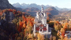 4k drone flight point of view (Ultra High Definition) of Neuschwanstein Castle, 19th-century hilltop fairytale castle. Wonderful autumn scene of Bavaria. Colorful landscape of Alps, Germany, Europe. - Powered by Shutterstock - Get 15% off with code: PIKWIZARD15