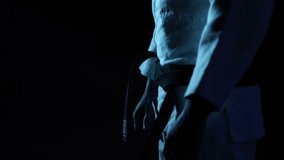 Close-up: Martial artist in meticulously ties their black belt in slow motion. Dark, moody atmosphere with cool blue lighting emphasizes focus and pre-fight ritual. - Powered by Shutterstock - Get 15% off with code: PIKWIZARD15