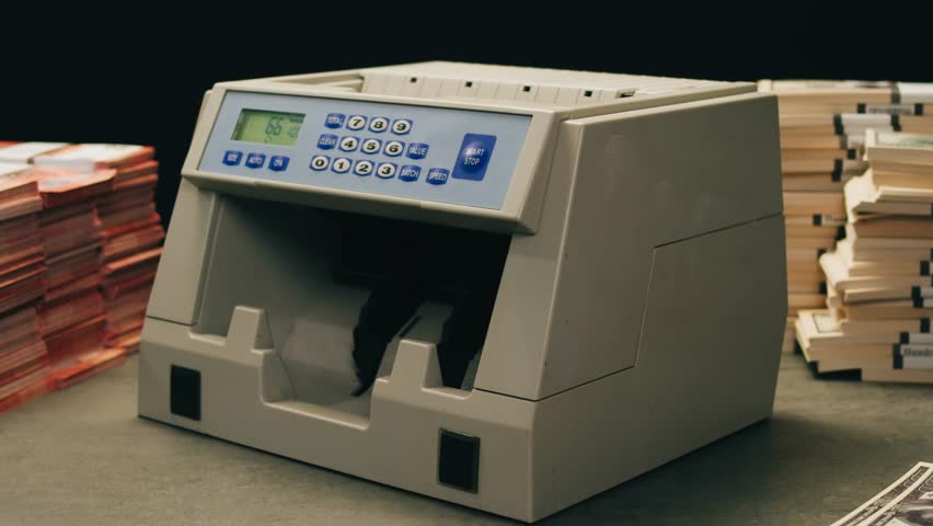 Banknotes and bag counter, Specialised police officer Counting dollar euro banknotes in crime lab with machine, cashed out criminal money, bitcoin changing, buying home flat in bank. 