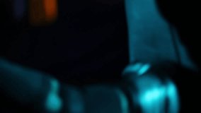 Close-up: Boxer's gloved fists repeatedly strike a heavy punching bag in a dark, moody gym. Teal light illuminates impact, emphasizing intense training and power. - Powered by Shutterstock - Get 15% off with code: PIKWIZARD15