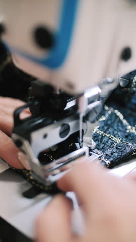 Seamstress working on sewing machine closeup