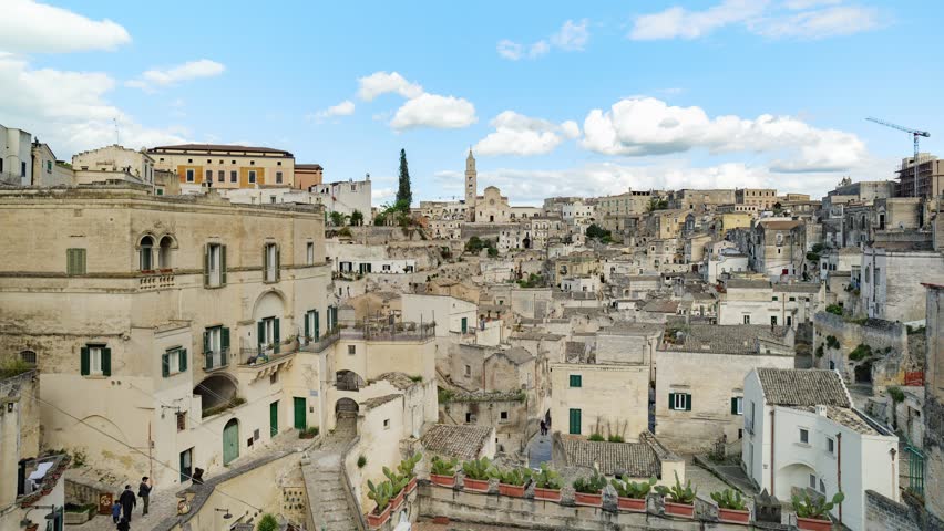 Sassi di Matera (MT), Italy. Panoramic view of the Sassi of Matera. On the top, the bell tower of the Basilica of Matera Maria Santissima della Bruna. Zoom in timelapse 4K video.