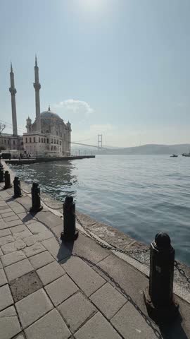 Ortakoy Mosque in Istanbul on a sunny day with a view of the Bosphorus Bridge