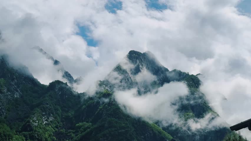 Breathtaking mountain peaks shrouded in clouds in northern Italy showcase stunning natural beauty and tranquility