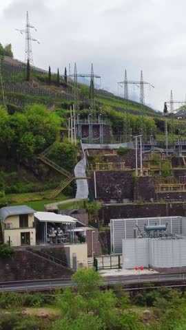 Vertical dolly shot moving backward from the hydroelectric plant St. Anton in alpine Italy