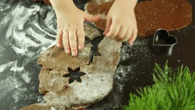 Child baking cookies, hands cutting dough with festive shapes on floured surface - Powered by Shutterstock - Get 15% off with code: PIKWIZARD15