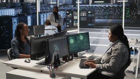 Scared technician in server room responding to hacking detection, requesting help from colleagues to protect critical data. Engineering team alerted by suspicious virus attack activity logs, camera A - Powered by Shutterstock - Get 15% off with code: PIKWIZARD15