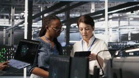 Data center teamworking colleagues performing maintenance on server racks used for artificial intelligence processing. Engineering team managing server hub rigs used for machine learning, camera A - Powered by Shutterstock - Get 15% off with code: PIKWIZARD15